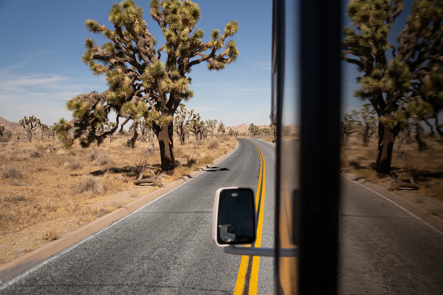 RV traveling through a desert landscape.