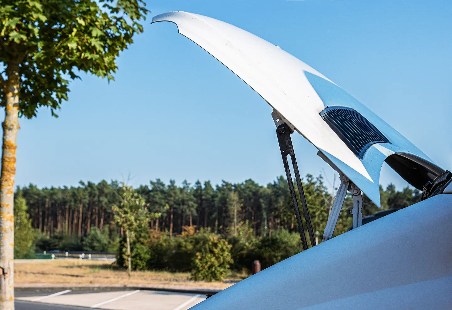 Open hood of a motorhome during inspection or maintenance.