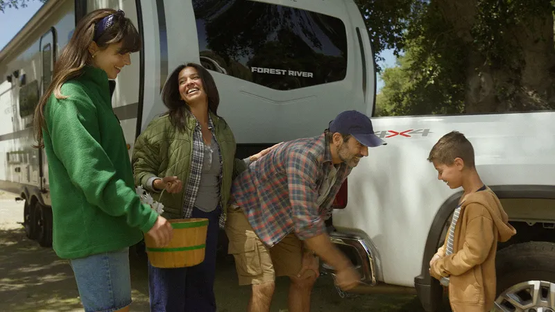 Family enjoying trip infront of the RV