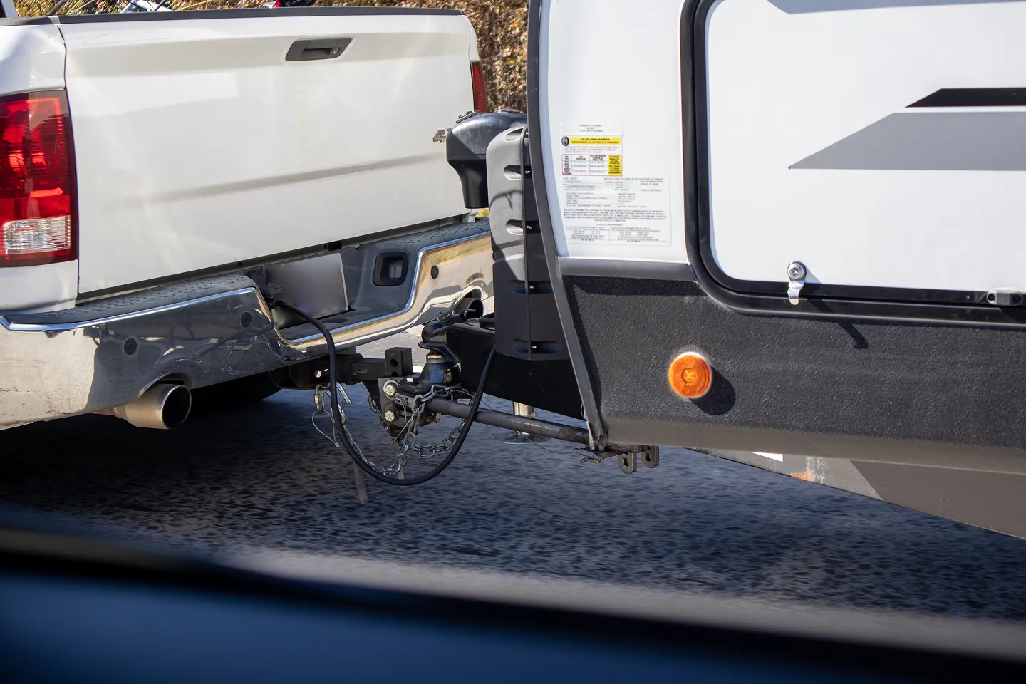 Travel trailer securely connected to a pickup truck hitch.