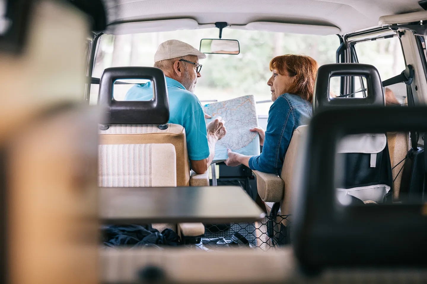 Two people reviewing a map inside a RV.