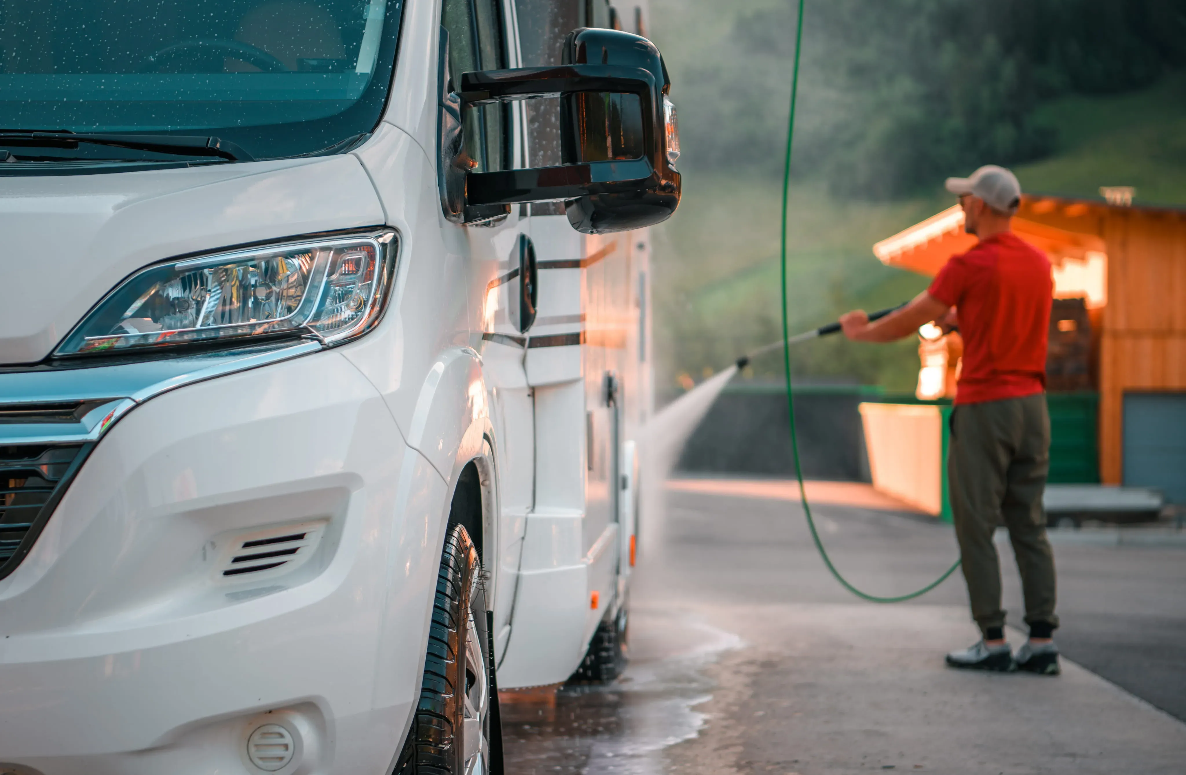 Technician pressure washing an RV.