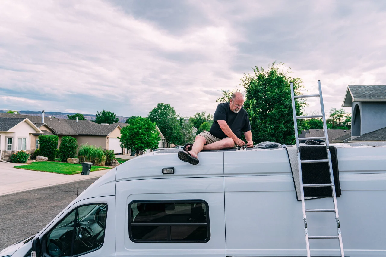 Technician working on the roof of a van.