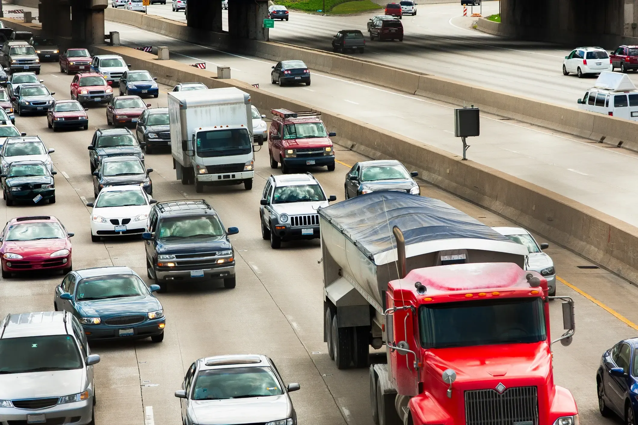 Congested multi-lane highway full of cars and trucks during a rush-hour traffic jam